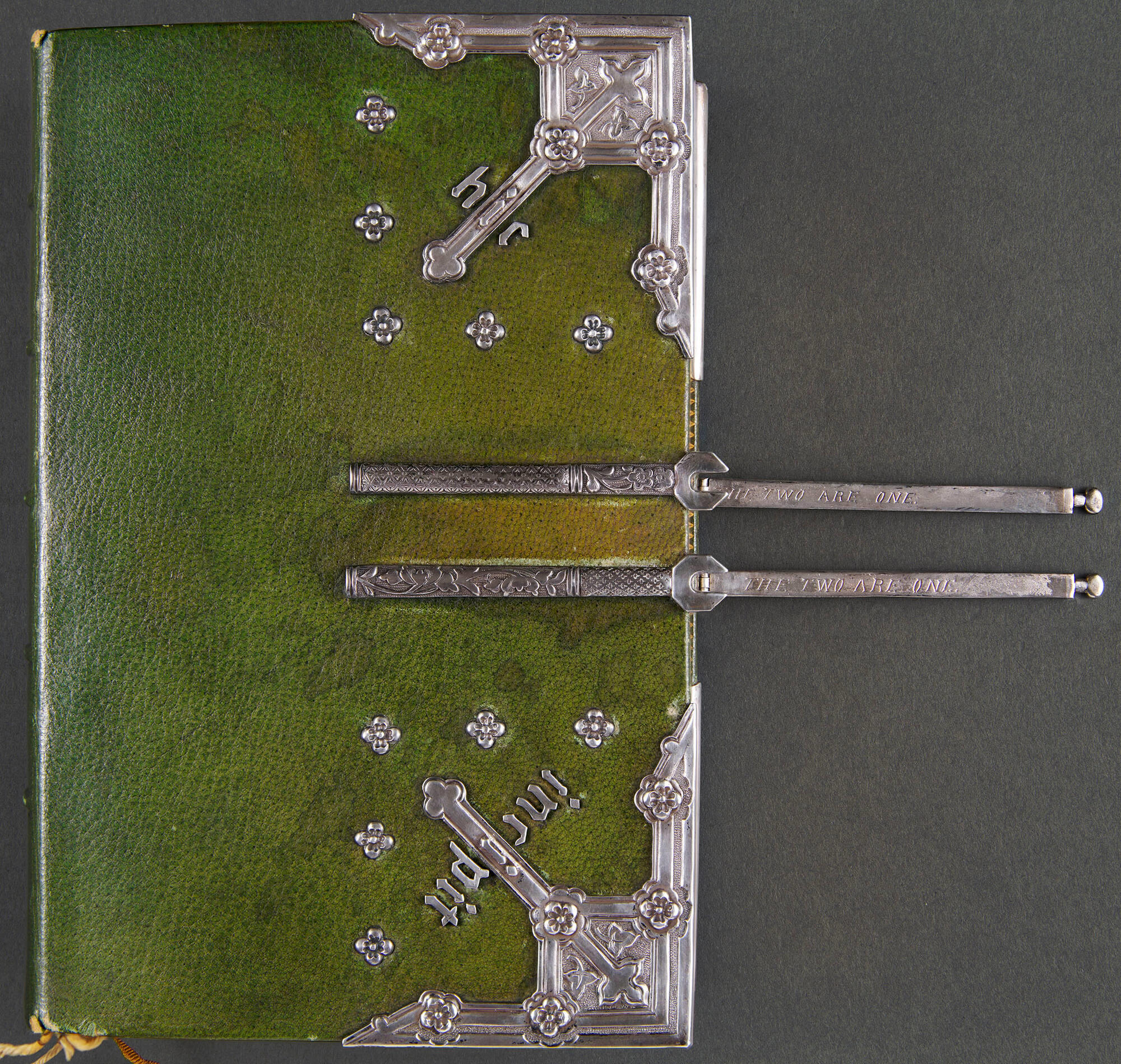  A book bound in green leather with silver decoration.