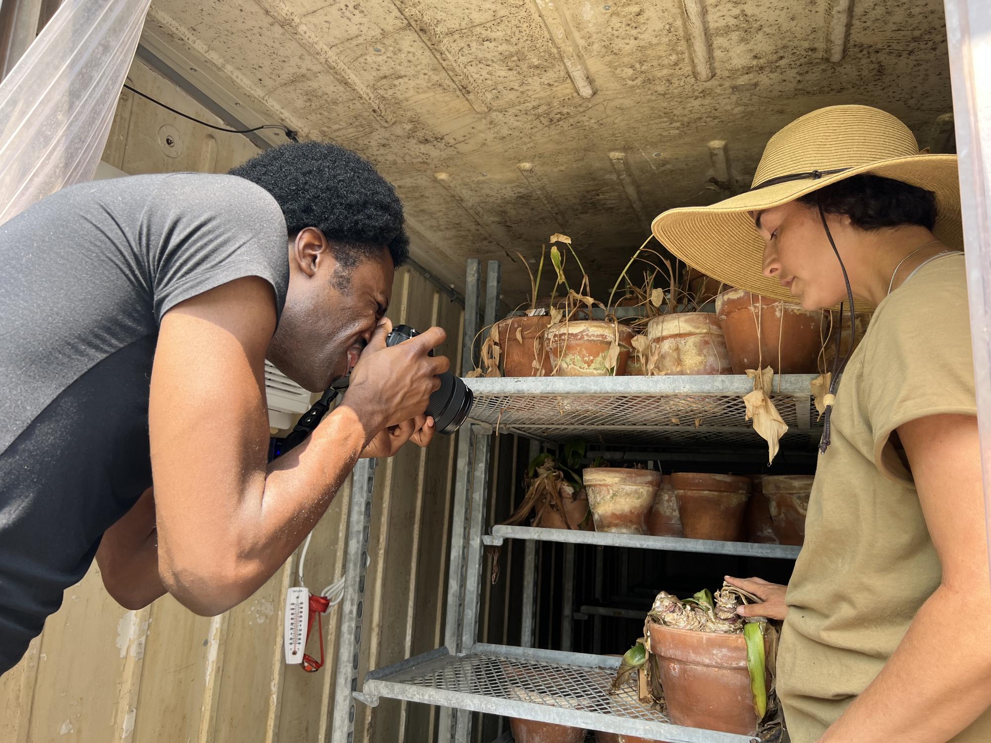 Man photographing clay pots in the Greenhouse 