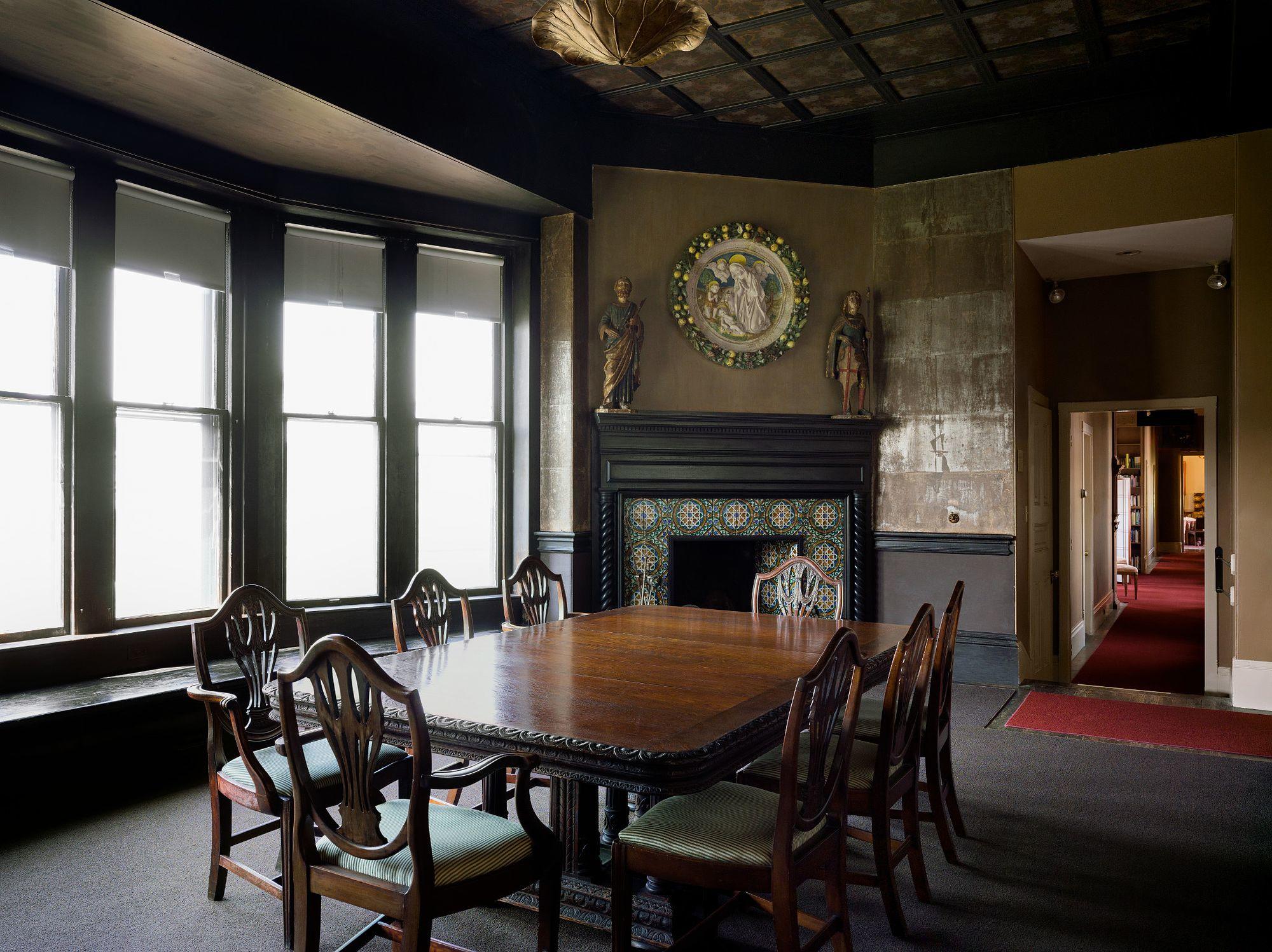 A tiled fireplace with a dark wood mantel.