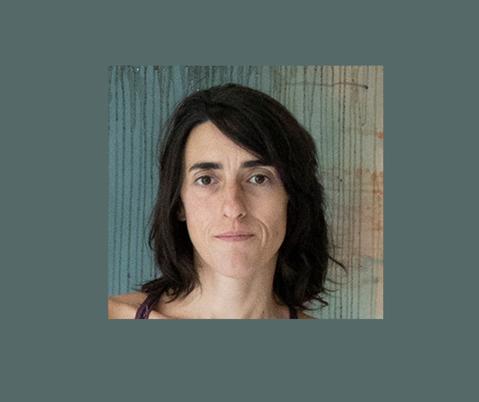 Headshot of a woman with shoulder length brown hair looking at the camera 