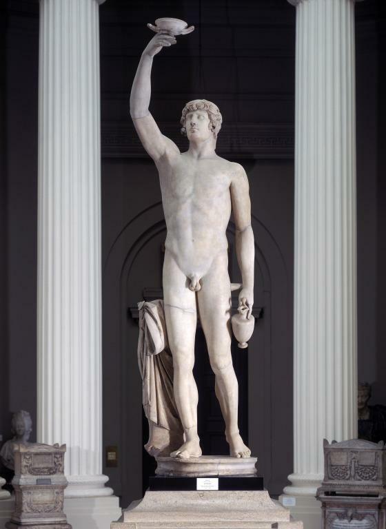 A marble statue of a nude male holding a vessel over his head and a jug by his side.