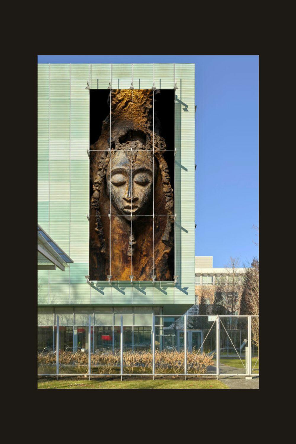 Facade image of a sculpture of a woman with closed eyes. 