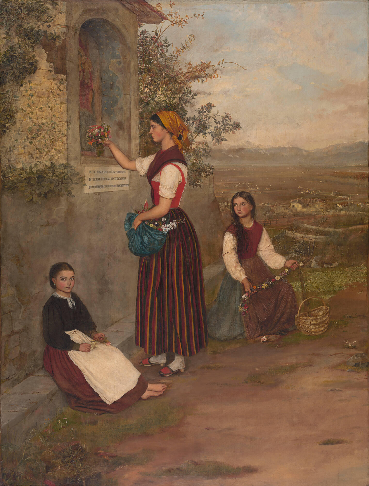 A painting of a young woman standing placing flowers in a niche along a road in the Italian countryside. She is flanked by two sitting girls who hold flowers.