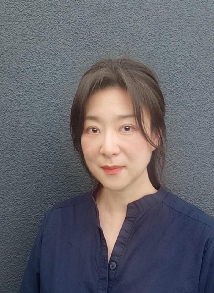 Young Asian woman looking directly at the camera. 