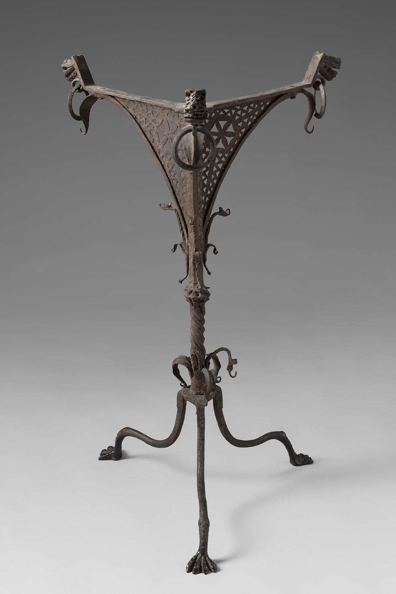 An iron stand with three feet.
