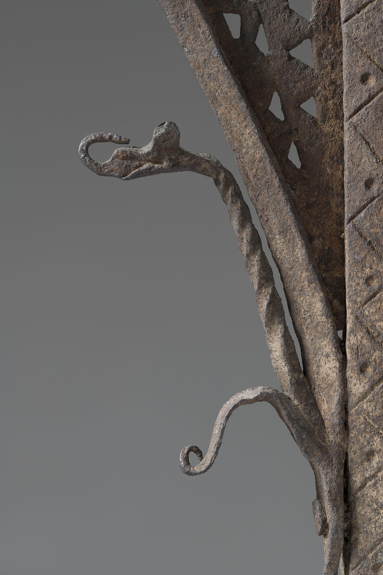 An iron dragon with its tongue licking its nose.