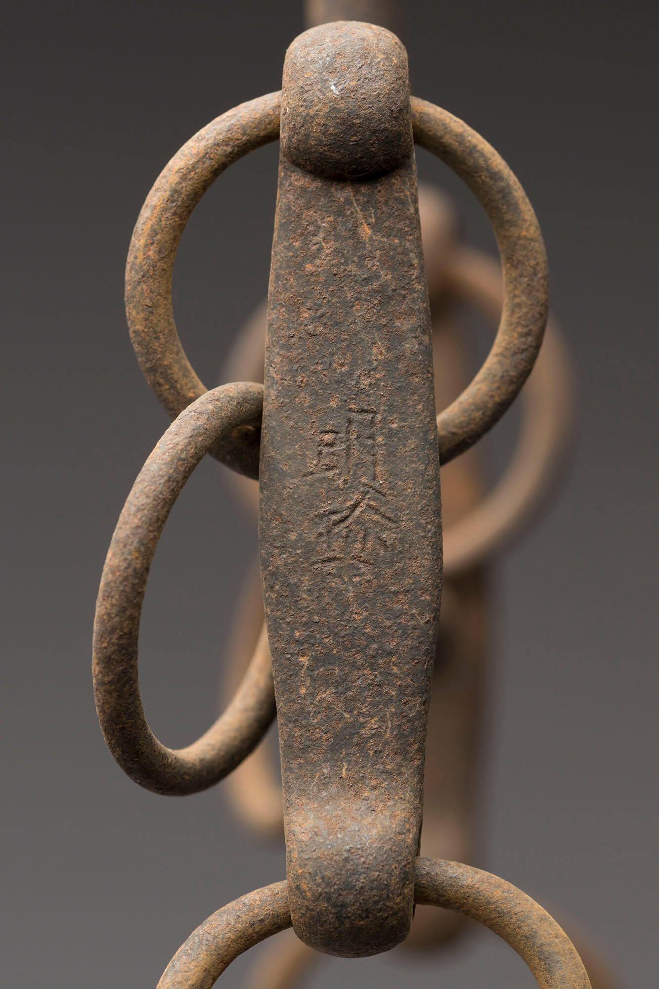 A detail of the horse muzzle’s bit with inscribed Japanese characters.