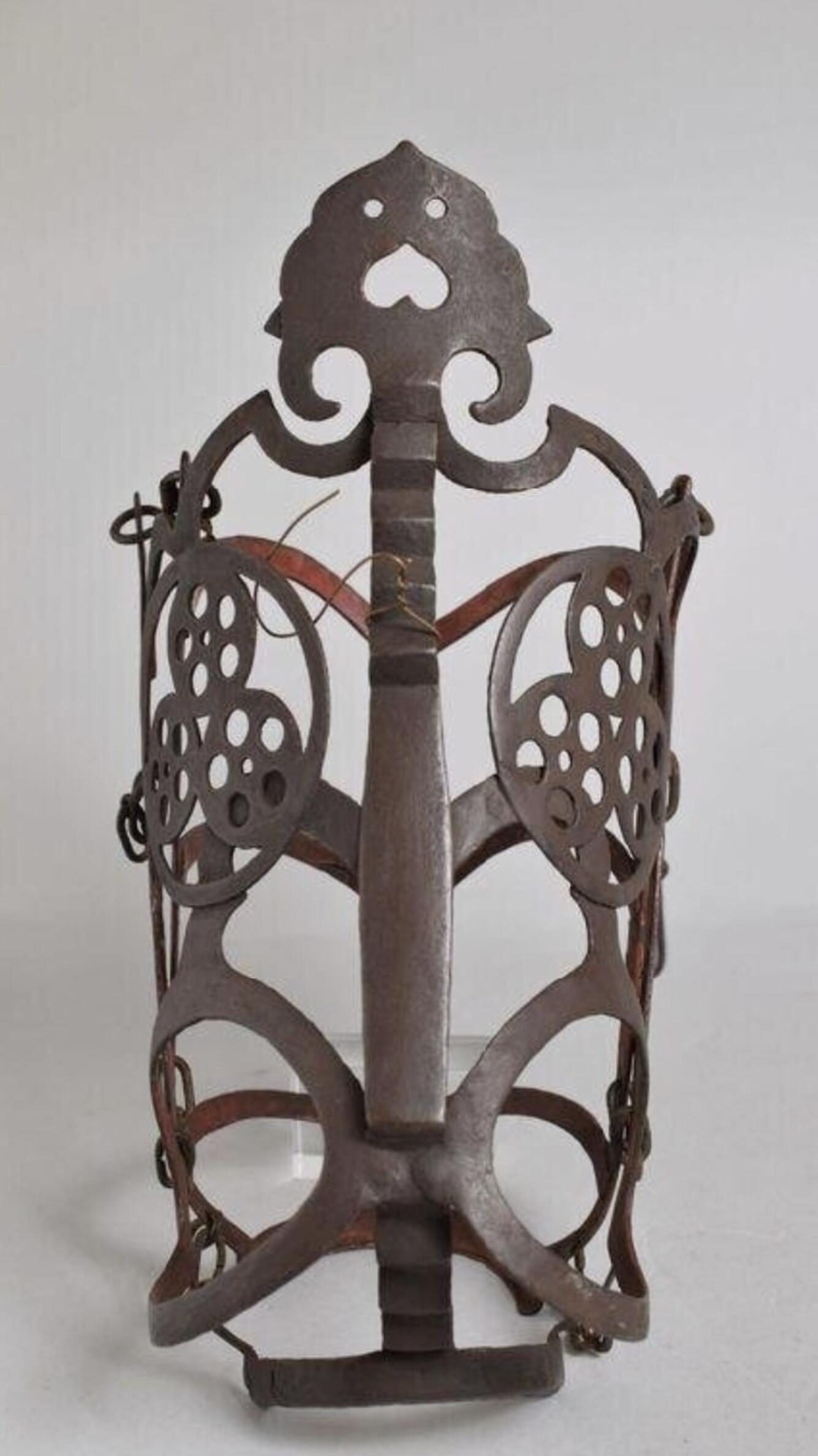  An elaborately decorated metal horse muzzle.
