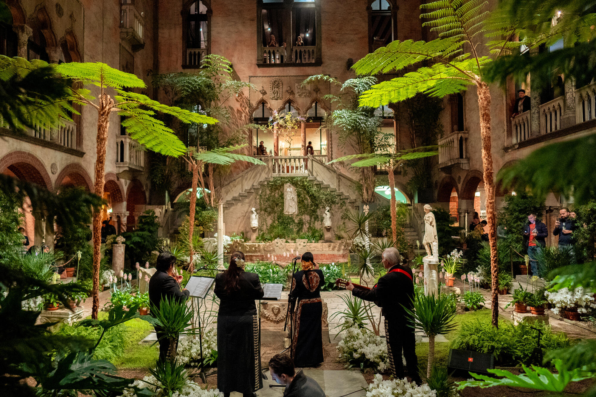 Four muscians playing instuments in the Court Yard 