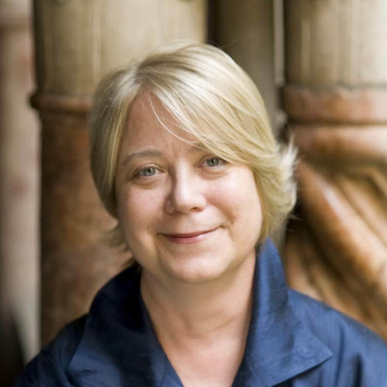 Headshot of a white woman with short blond hair looking directly at the camera 