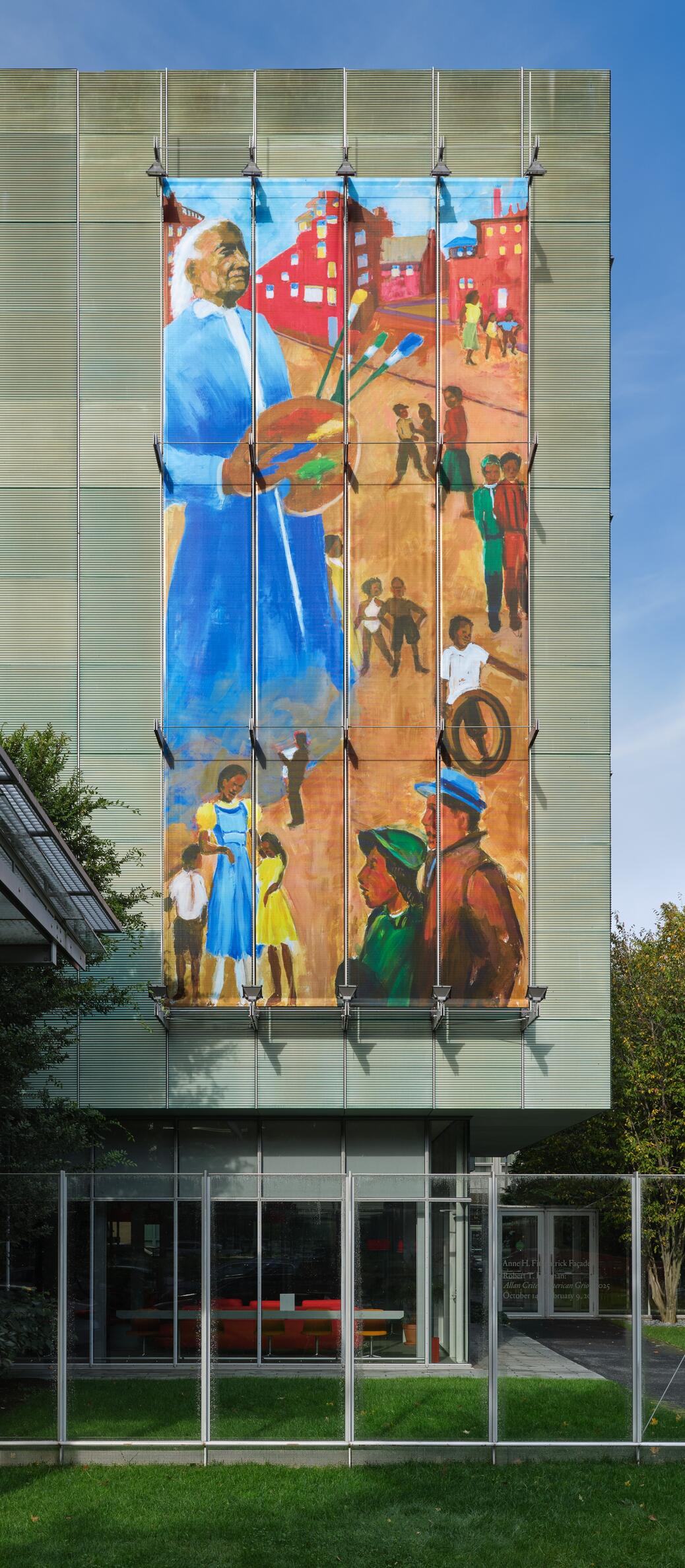 A large image on the facade of the Museum with a very tall, African American man with white hair standing among smaller groups of people, holding a paint palette.