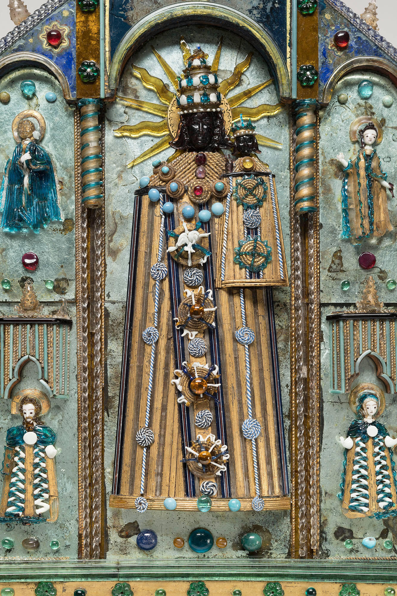 The Virgin and Child made in glass. Both figures have black faces and hair.