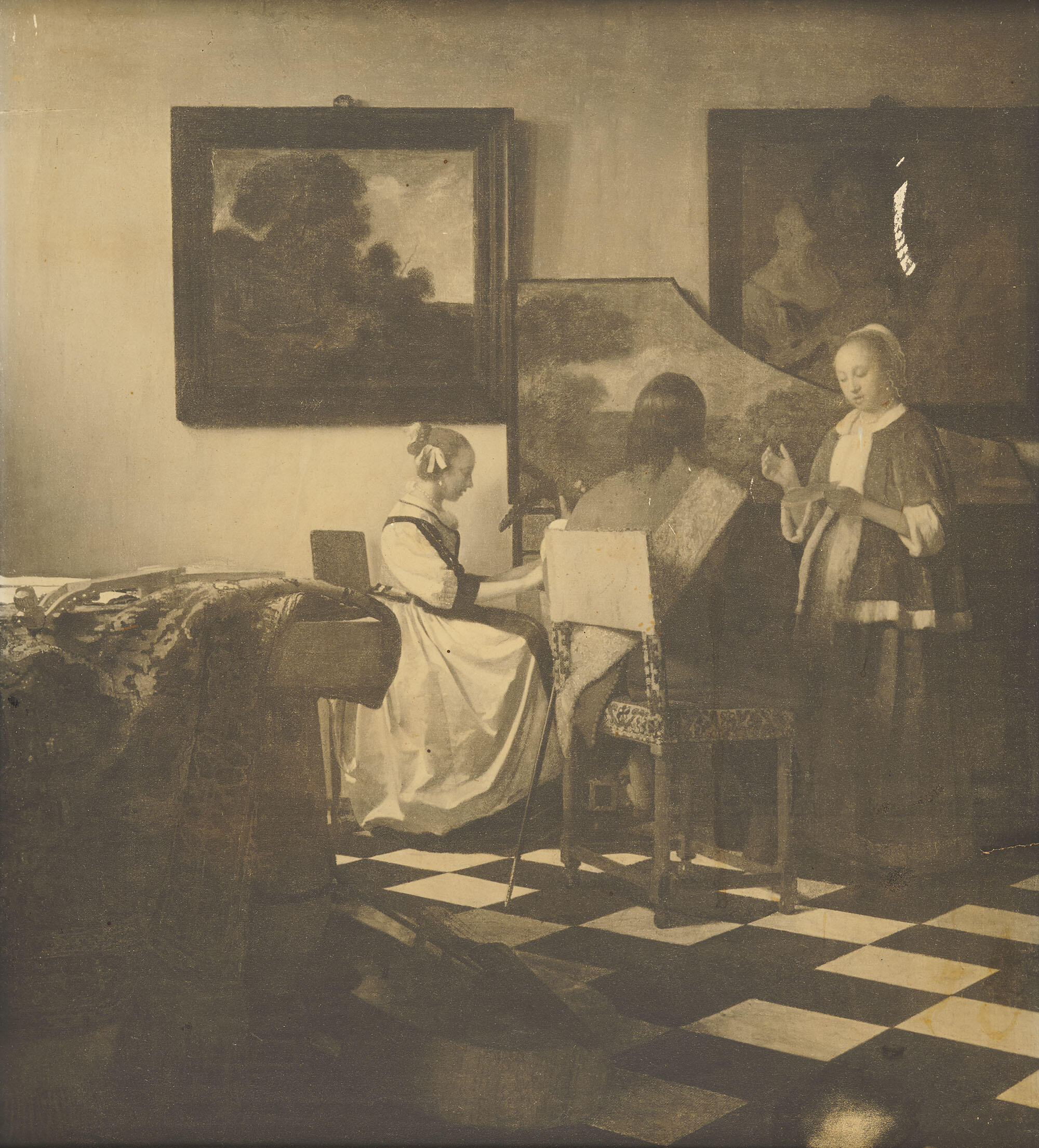 Photograph of a painting of two women and a man sitting in a music room; one woman is seated at a harpsichord, other instruments are displayed about the room.