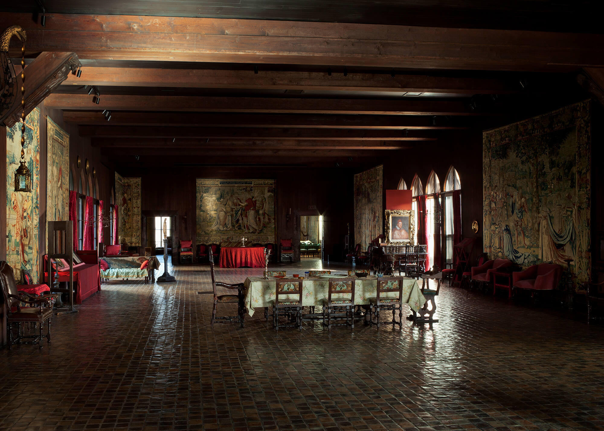 A large gallery with tapestries on the wall.