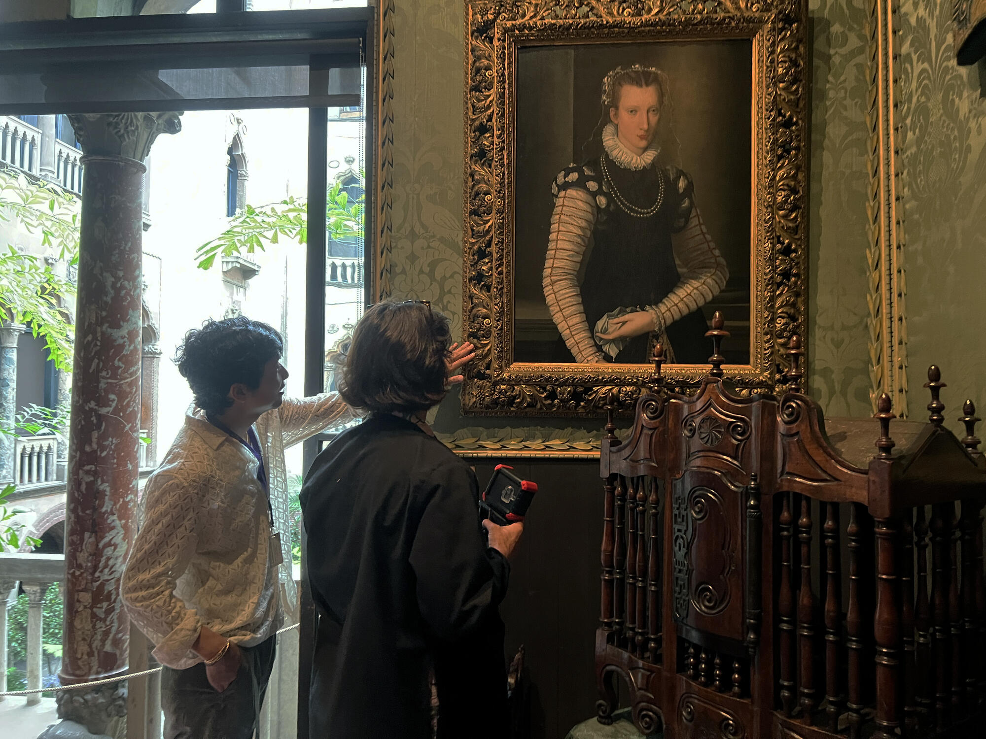 A man and woman looking at a painting in the Dutch room. 