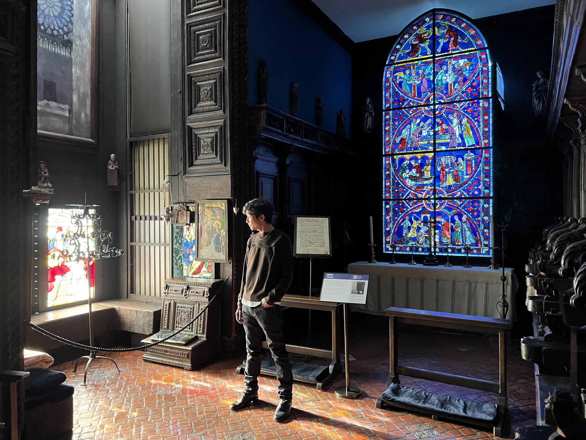 Asian man wondering through an gallery by himself. 