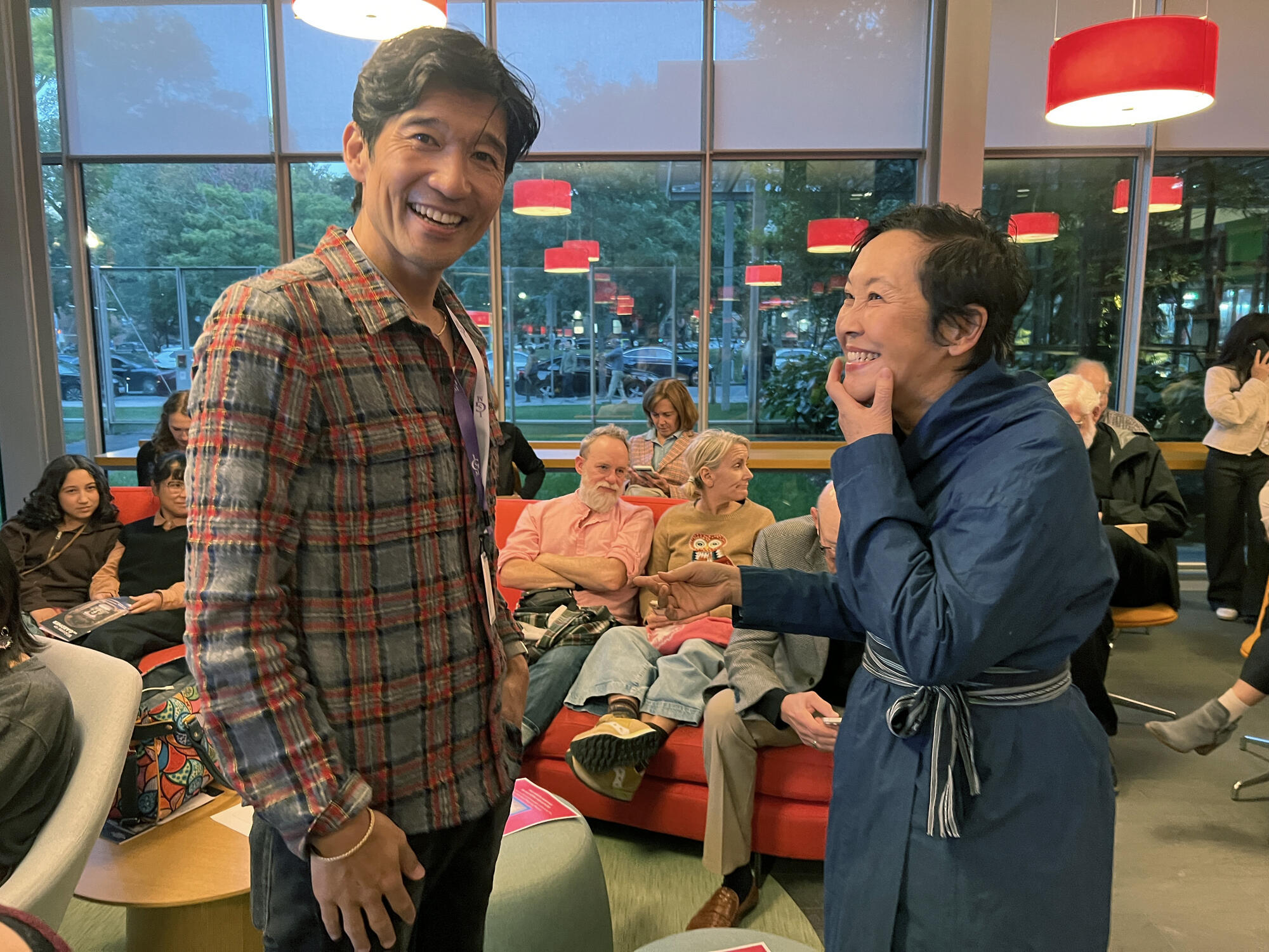 An Asian man and woman sharing a laugh in the Living Room