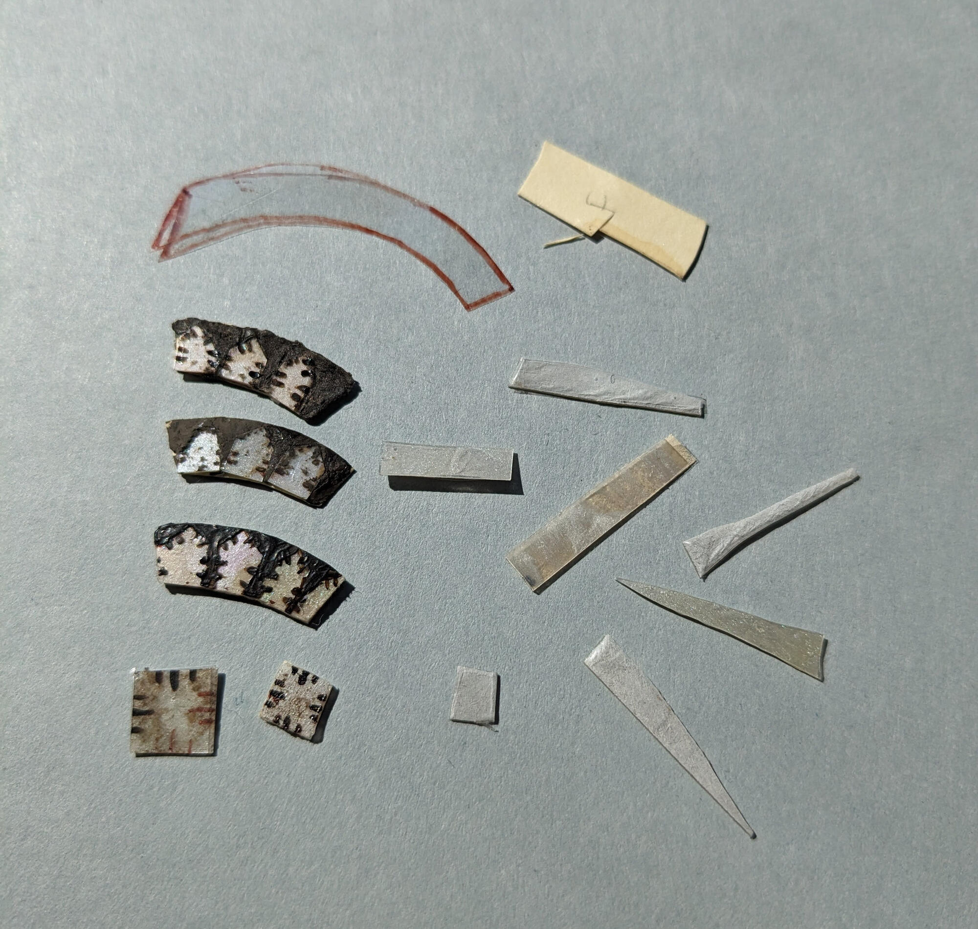 Various stencils and cutouts of the imitated mother-of-pearl as mock ups. 