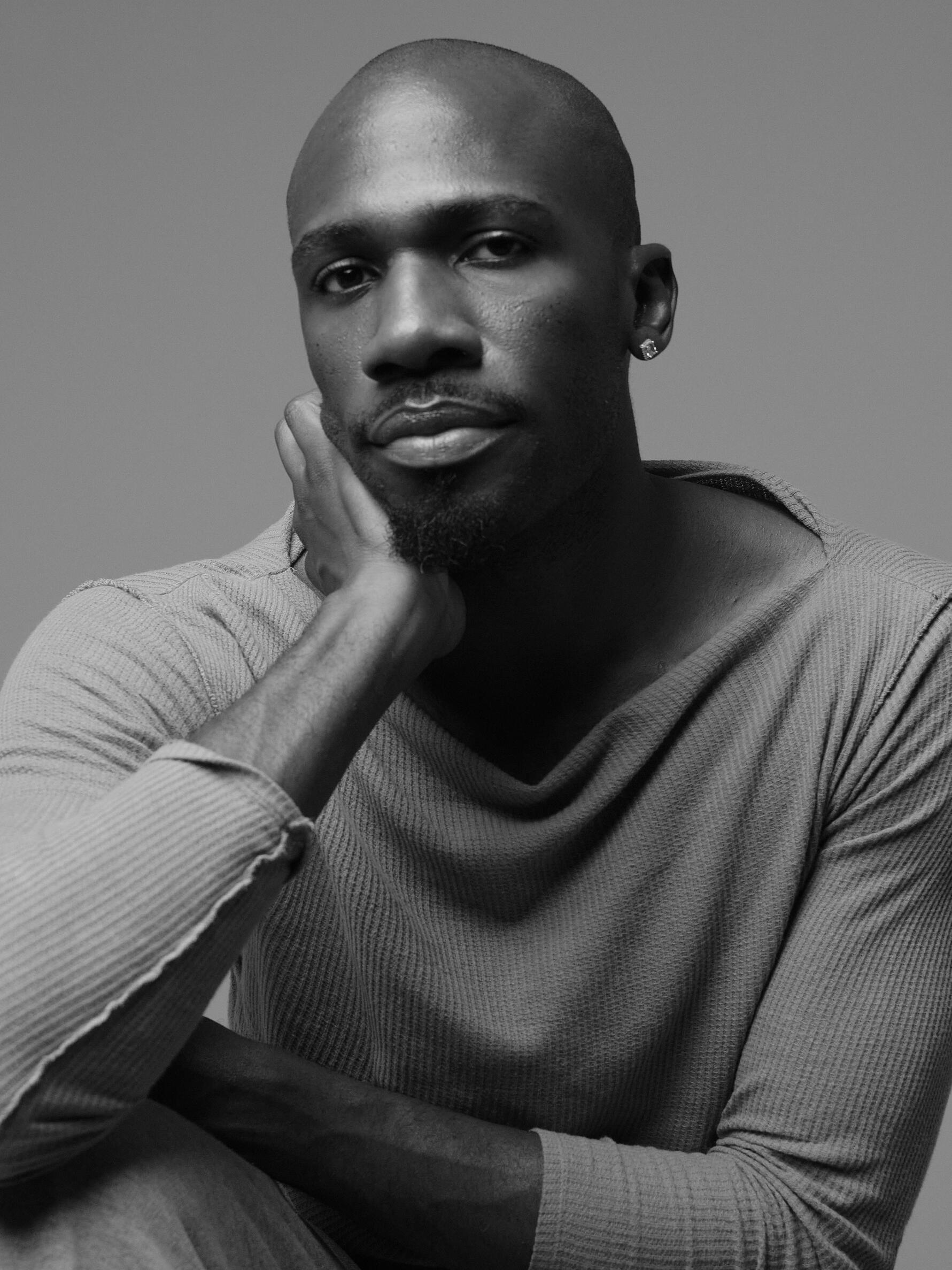 Black and white photo of a bald, African American Man