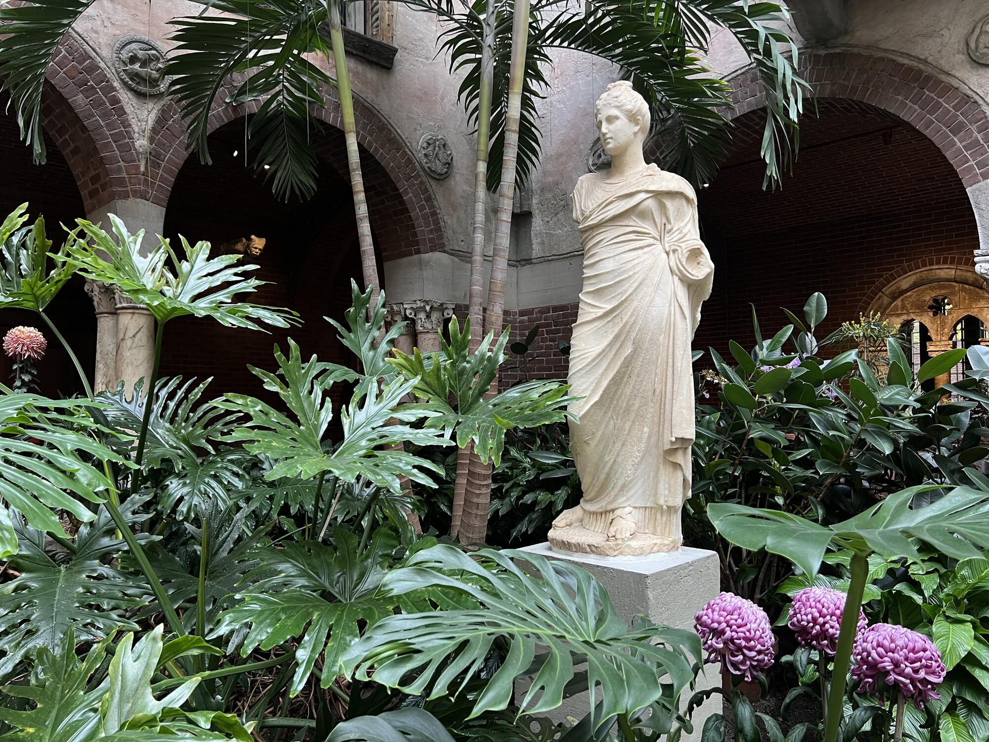 A statue of the Goddess Persephone draped in robes.