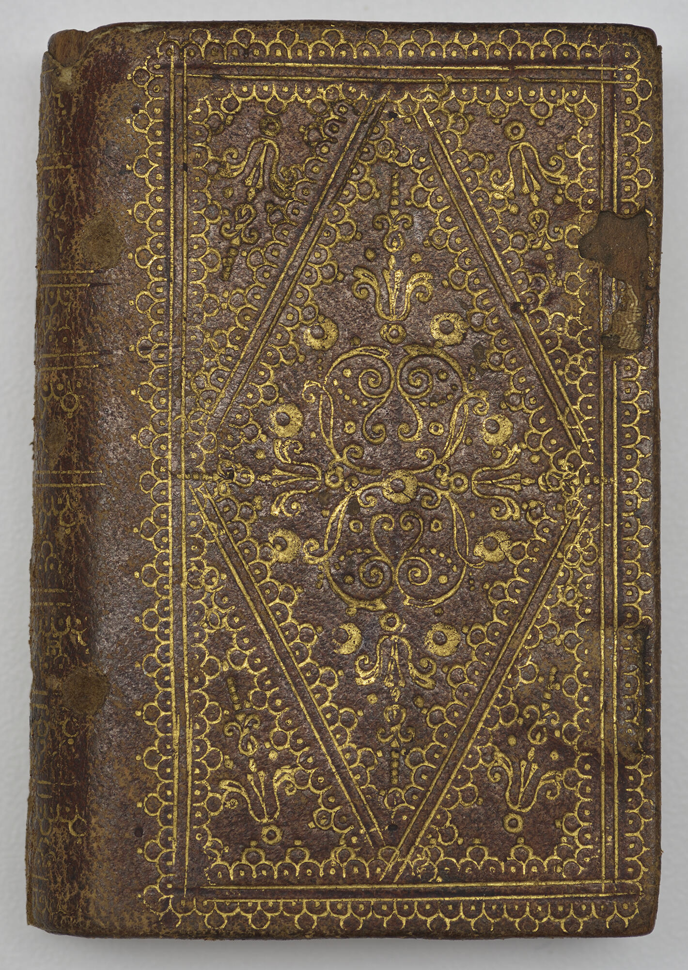 A brown leather rectangular box with gold decoration.