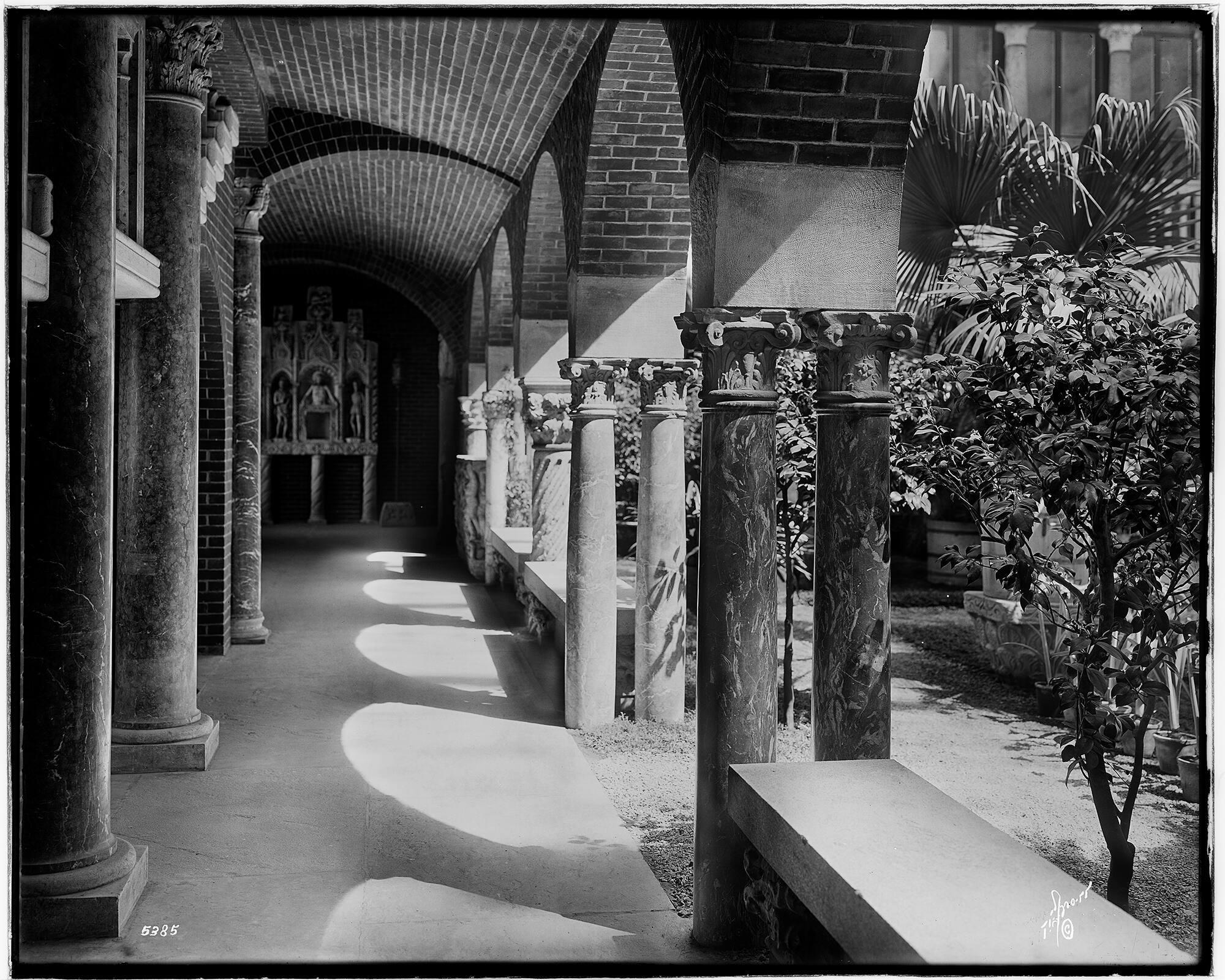 A black and white photograph of the exterior of the Isabella Stewart Gardner Museum from the Fenway with the Muddy River in the foreground.