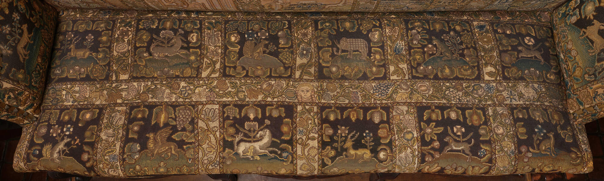 The seat of the sofa with square embroideries showing different animals