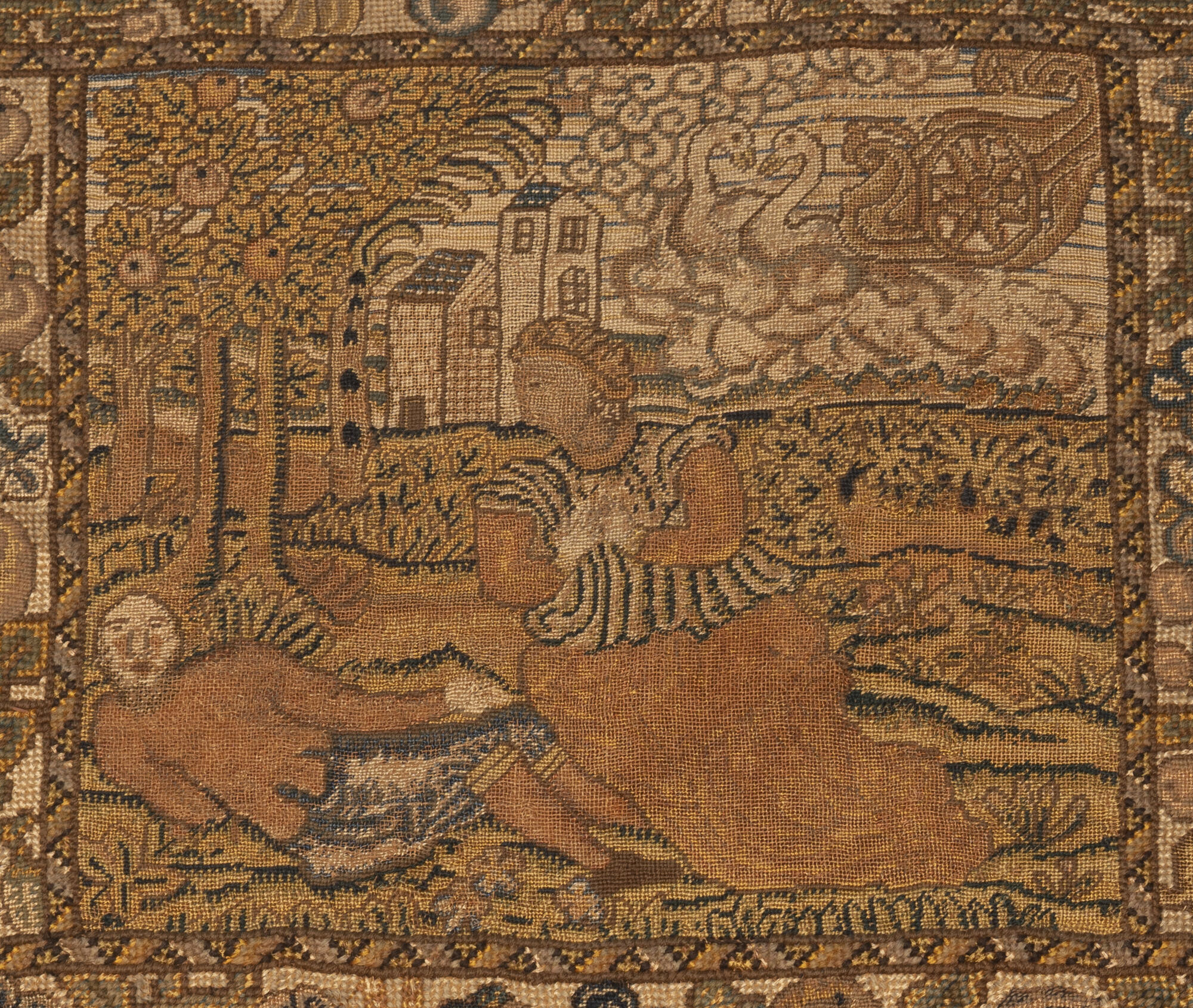 An embroidered square of two figures in a landscape and a swan chariot in the sky