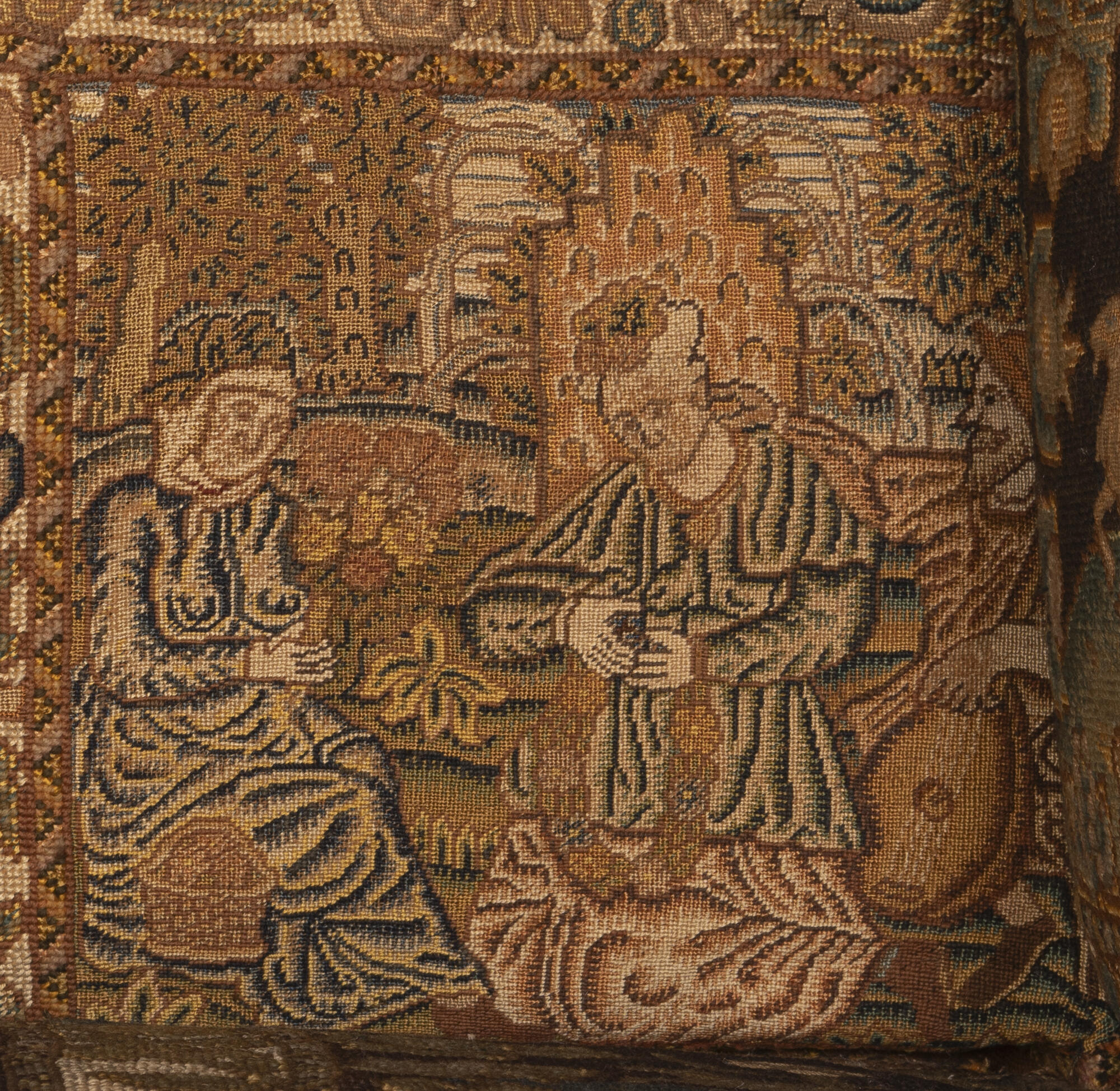 Two embroidered squares. The left with an indoor feast. The right with a couple around a hearth with a fire.