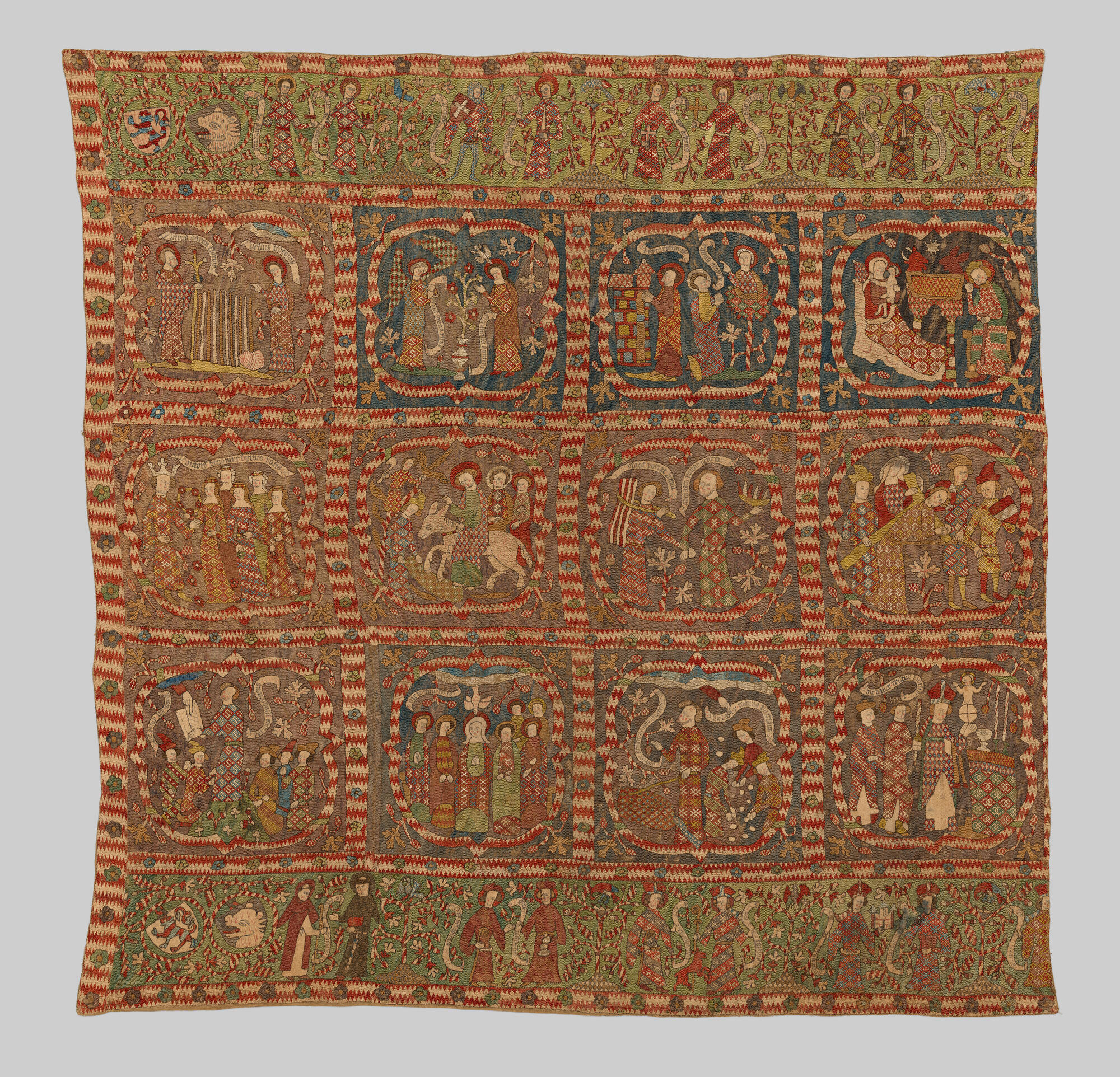 An embroidered square depicting lives of saints