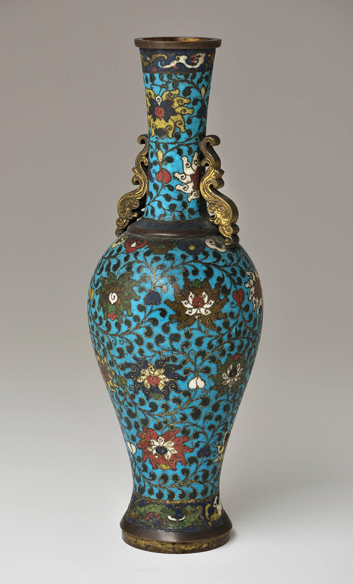 A blue, flowered enamel vase.
