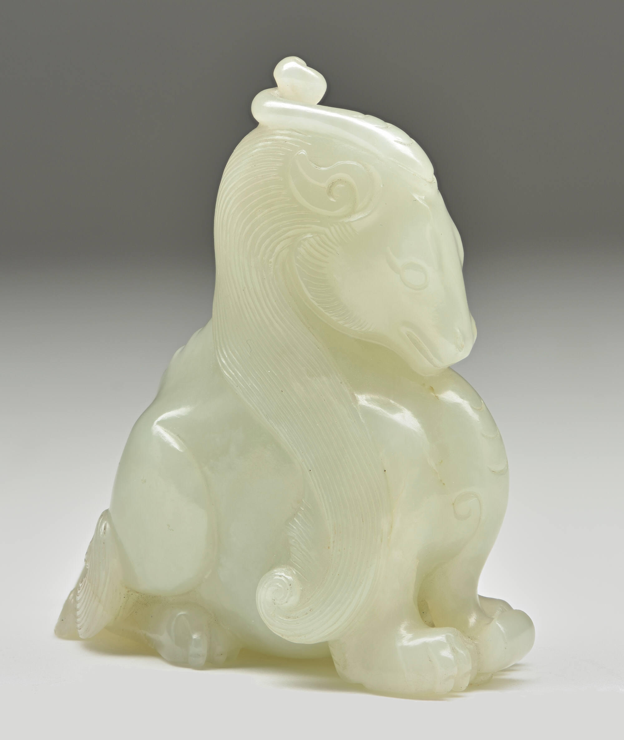A horse carved out of light green stone.