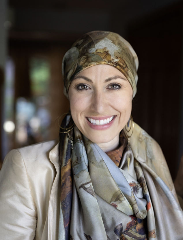Headshot of a white woman wearing a head scarf