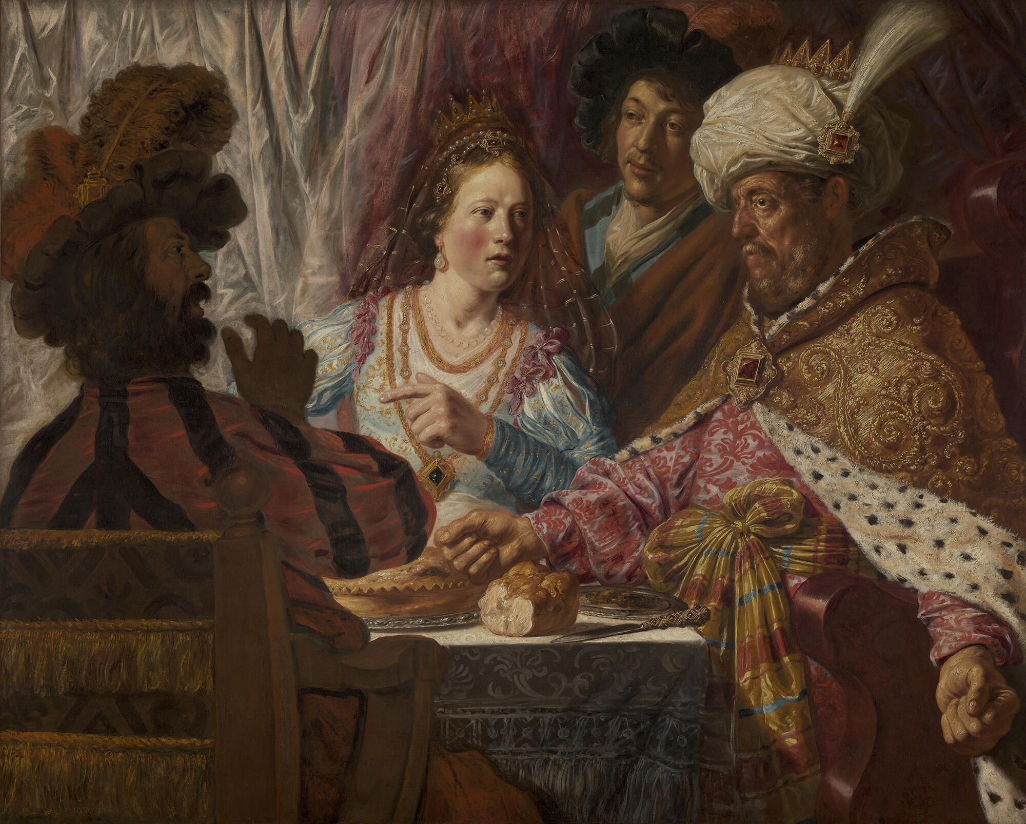 A painting of a light skinned young woman wearing a dress and cloak with metallic threads is seated in a chair. A woman in a plain hooded robe stands behind her and combs her hair.