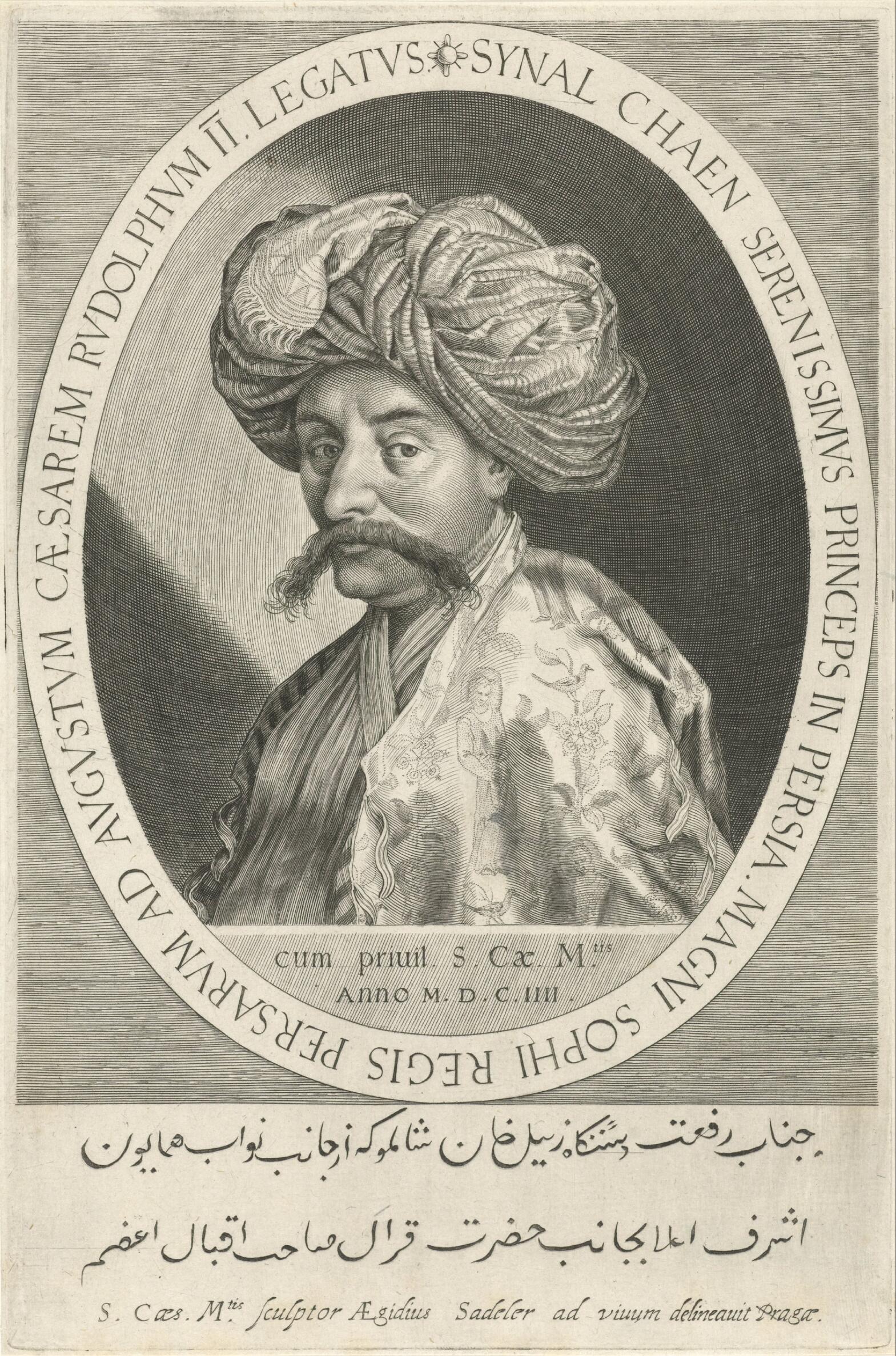 The head and shoulders of a man set in an oval surrounded by an inscription. The man has a dark mustache and wears a turban and robes.