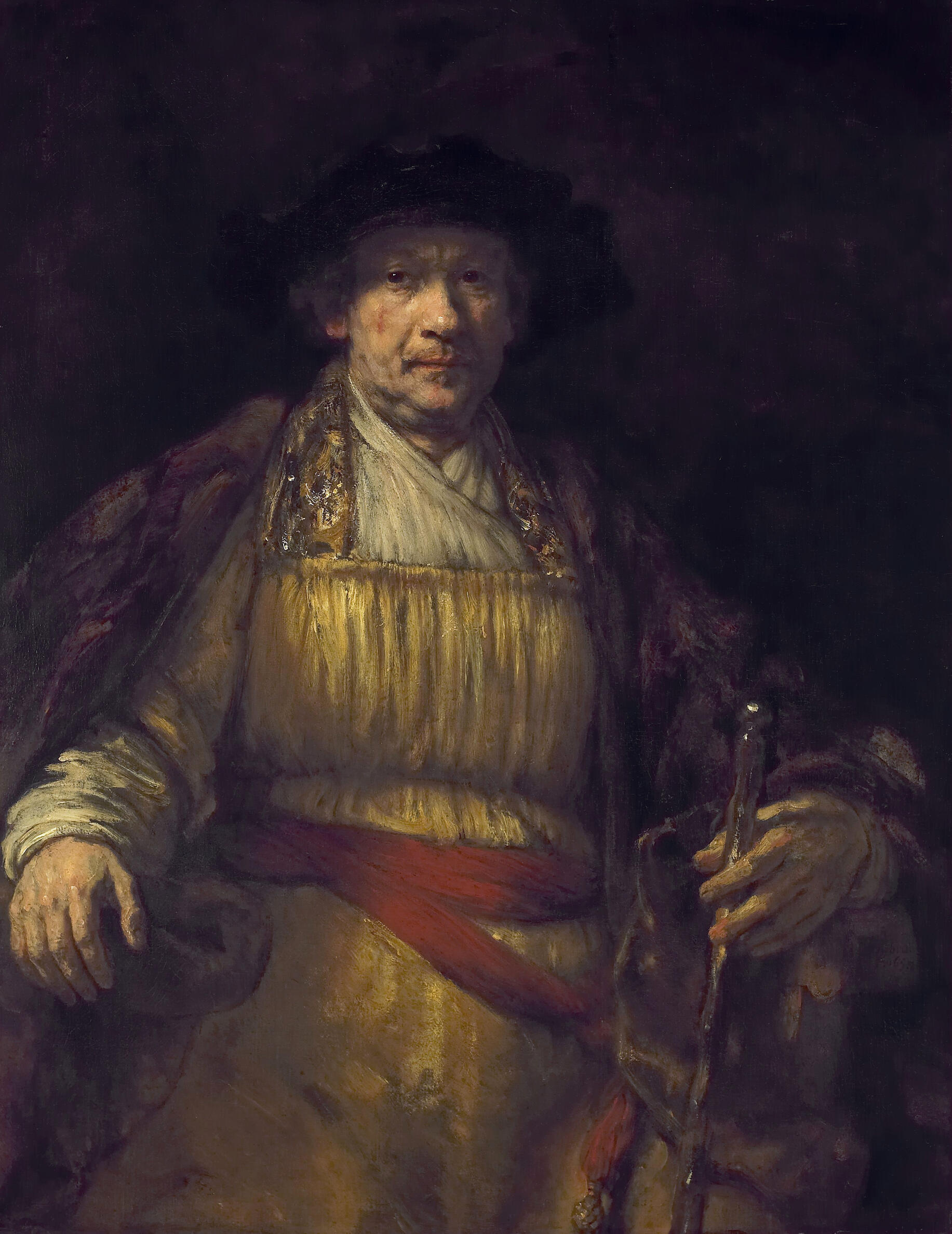 A seated older man from the knees up with pale skin wears yellow robes and a fur cloak. He holds a scepter, wears a hat, and looks directly at the viewer.
