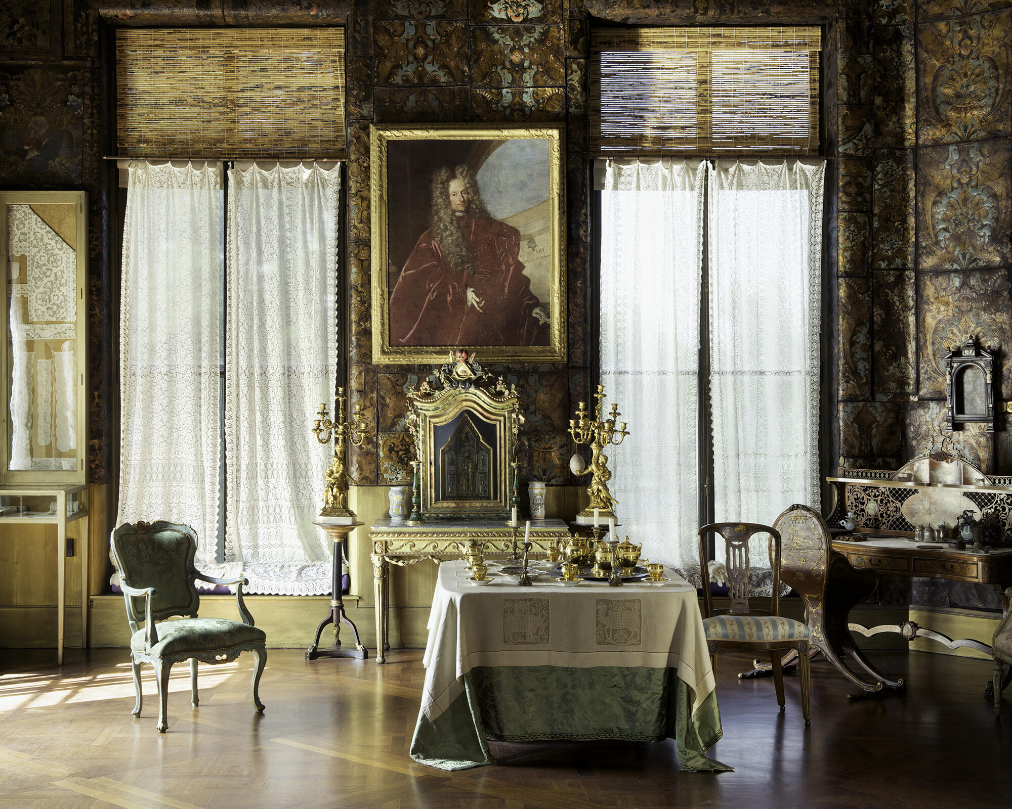 A room with leather wall panels and a portrait of a man.