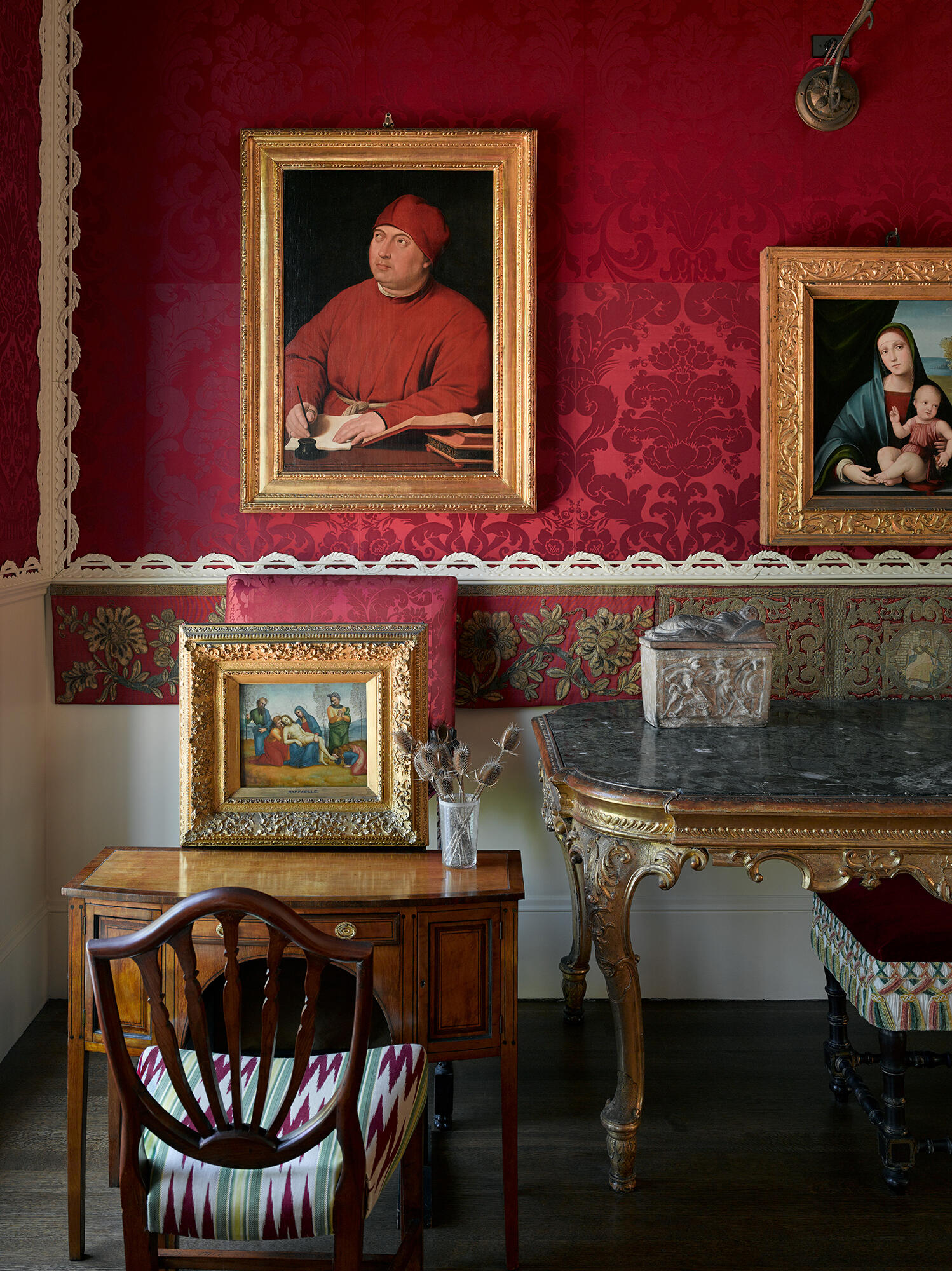 A room with tapestries on the walls and comfy looking chairs.