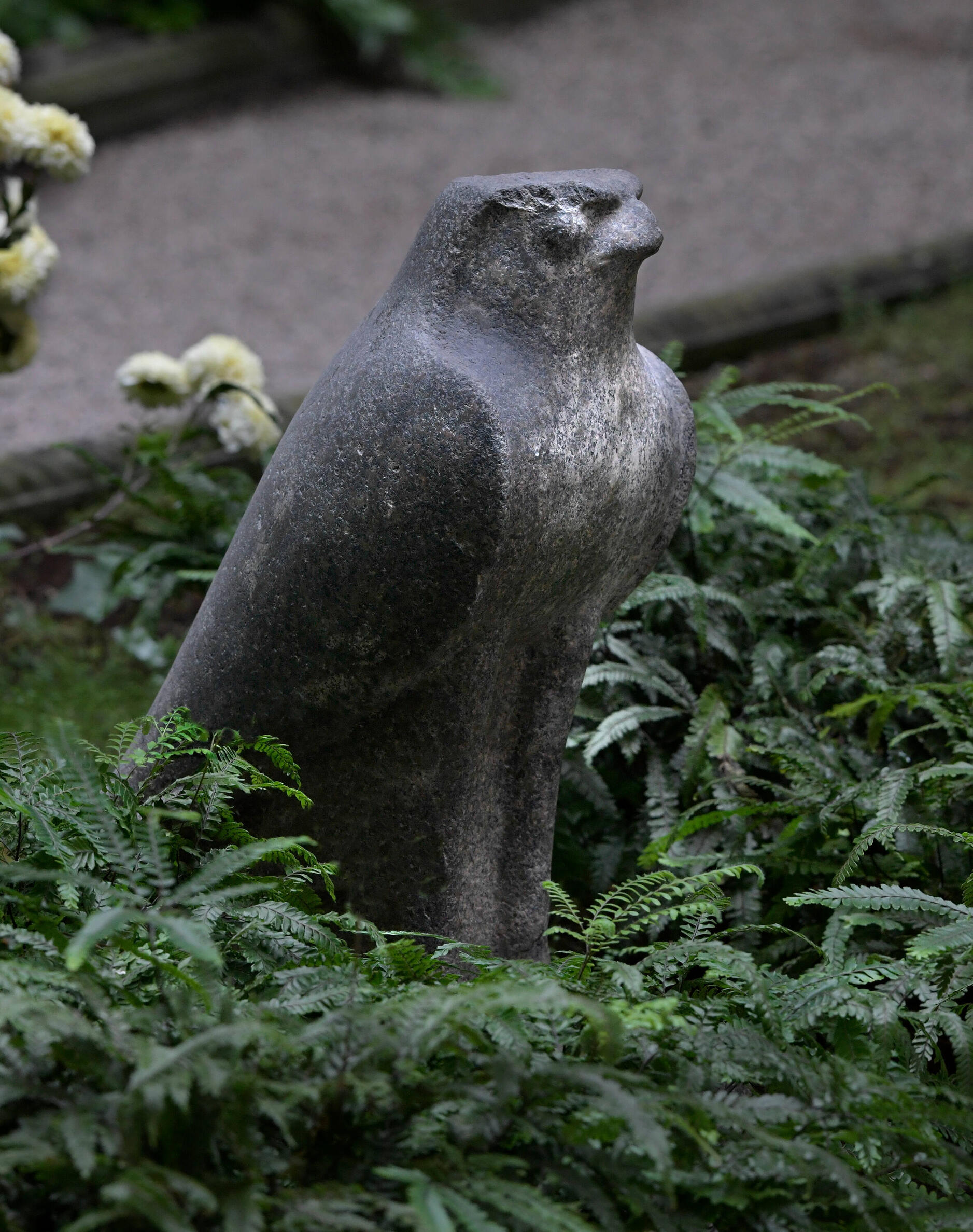 Stone sculpture of a stylized falcon. 