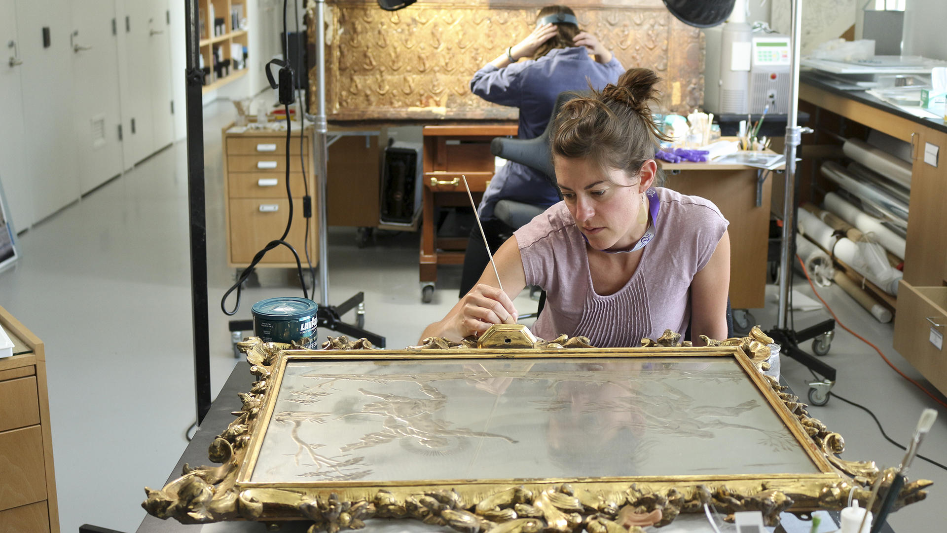 An ornate frame being worked on in the Isabella Stewart Gardner conservation labs