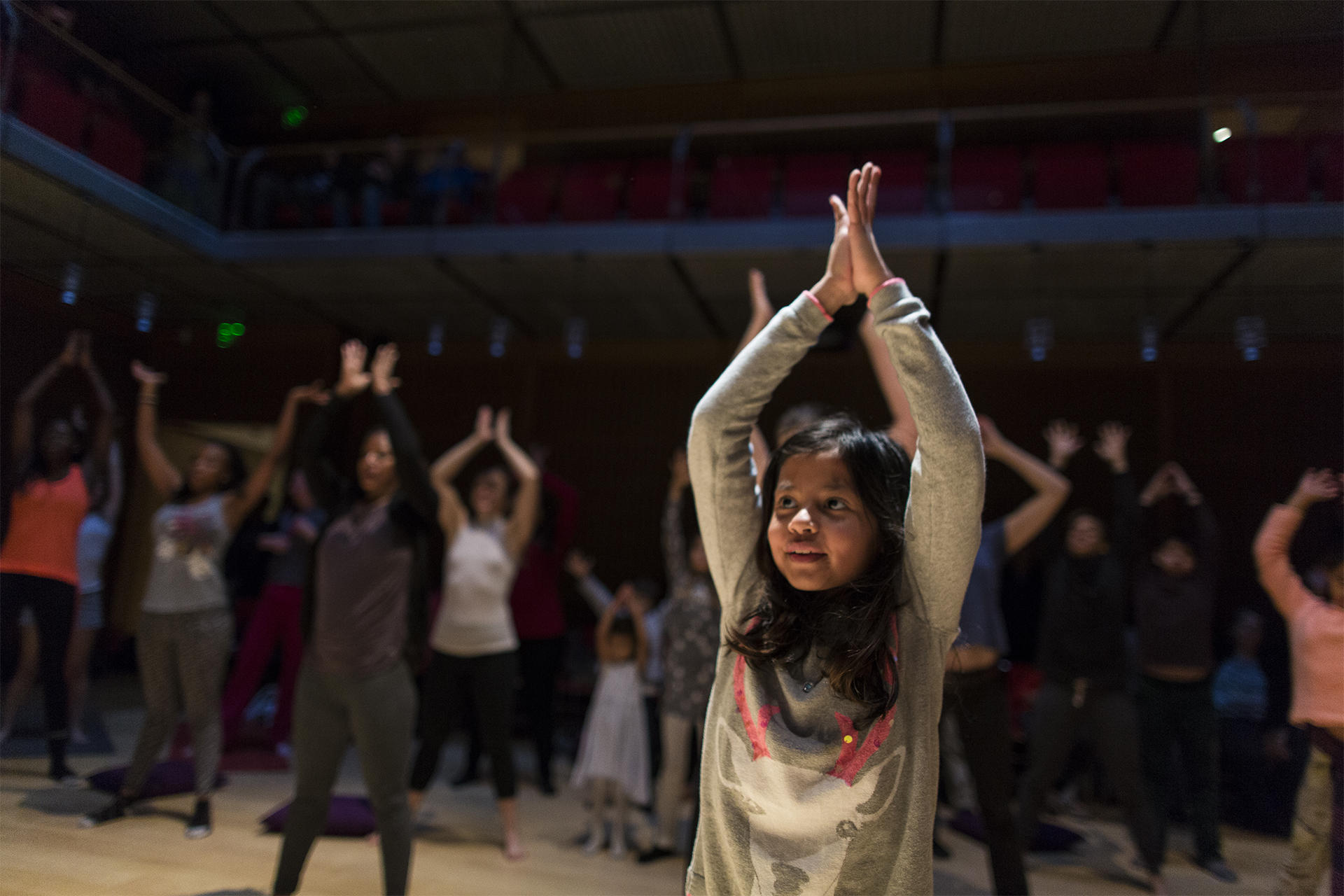 Visitors engaging in Afro Flow Yoga in Calderwood Hall. Photo by Leonardo March.