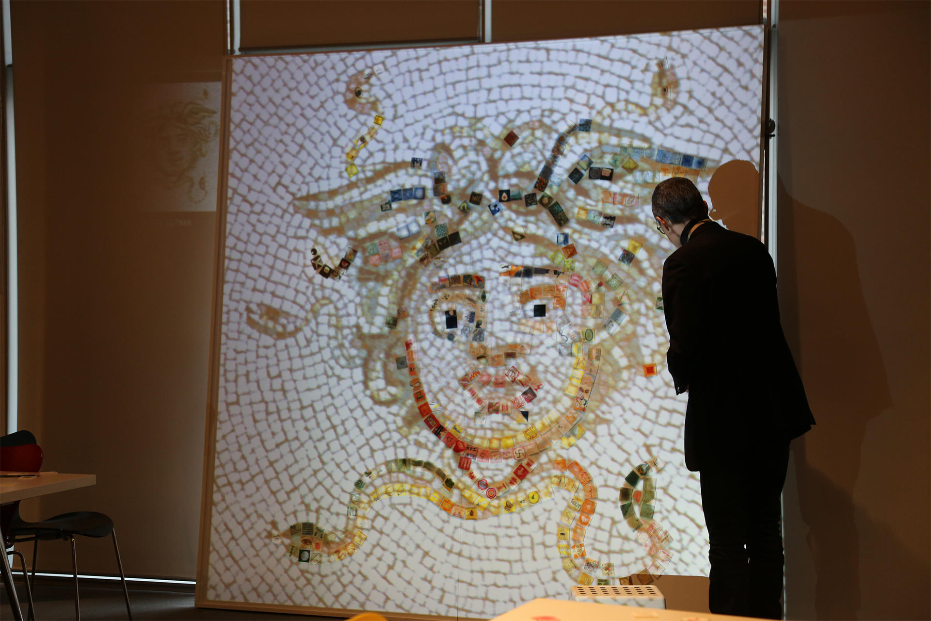 Cesare Pietroiusti with a projected image of the Courtyard Medusa Mosaic