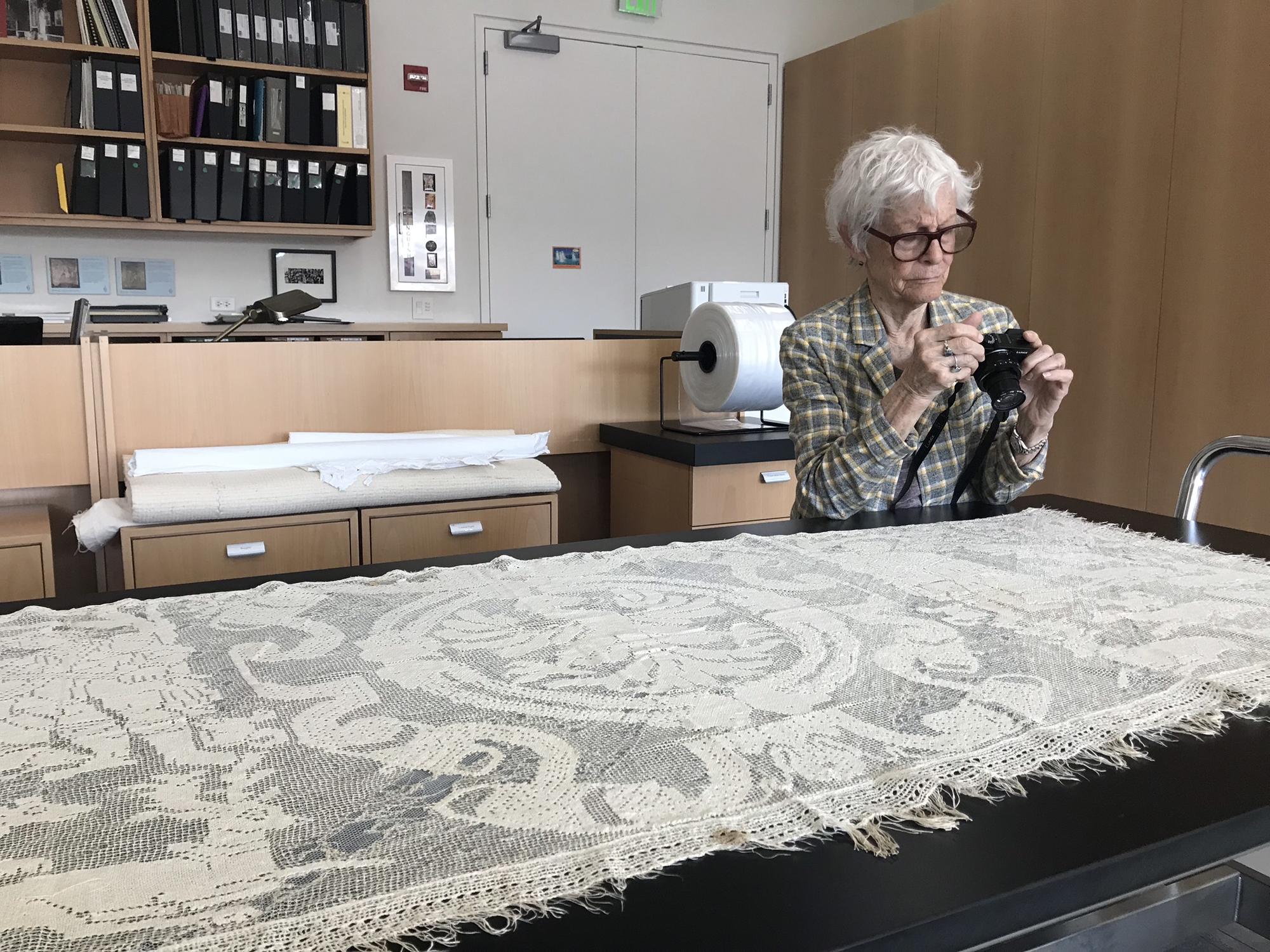 Joan Jonas photographing lace in the Textile Conservation Lab, 2018.