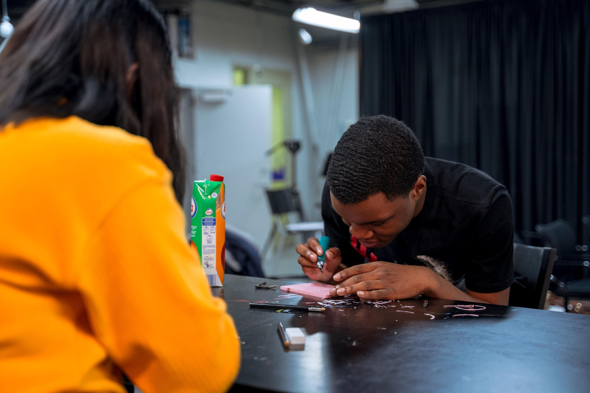 An Urbano Project student carves a linoleum tile, the first step in print-making. Photo by Faizal Westcott, June 2019.