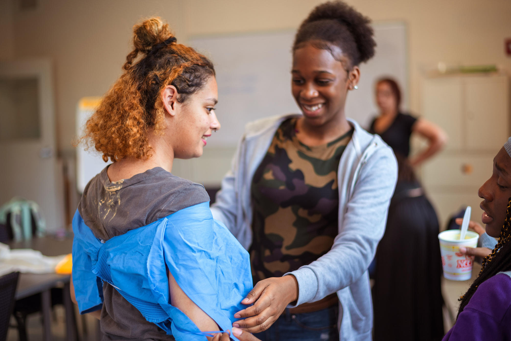 Two Hyde Square Task Force students work together to check the fit of their garments. Photo by Faizal Westcott, June 2019.