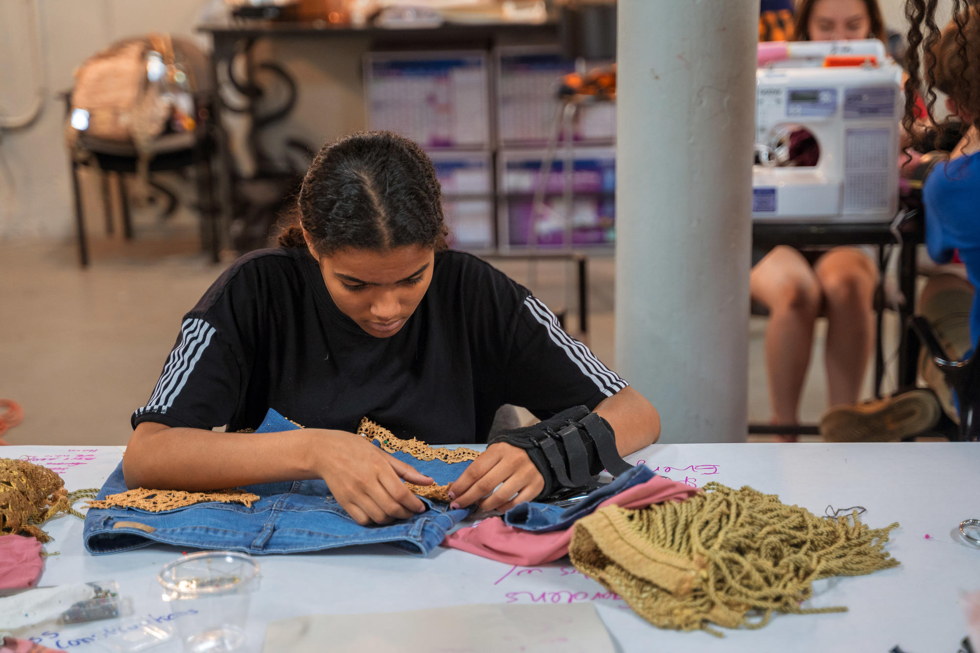 An Urbano Project student works on their Map This garment.