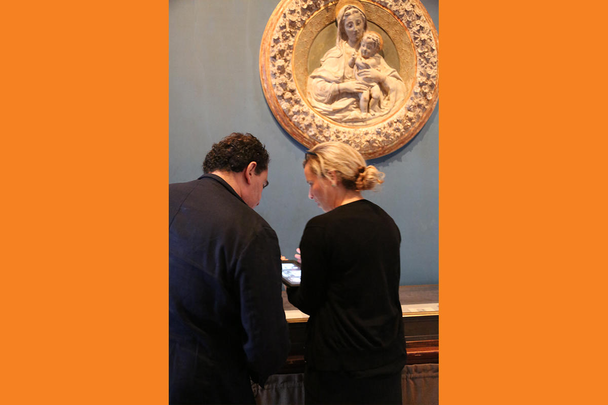 Javier Téllez examines objects in the galleries with Senior Archivist Shana McKenna.