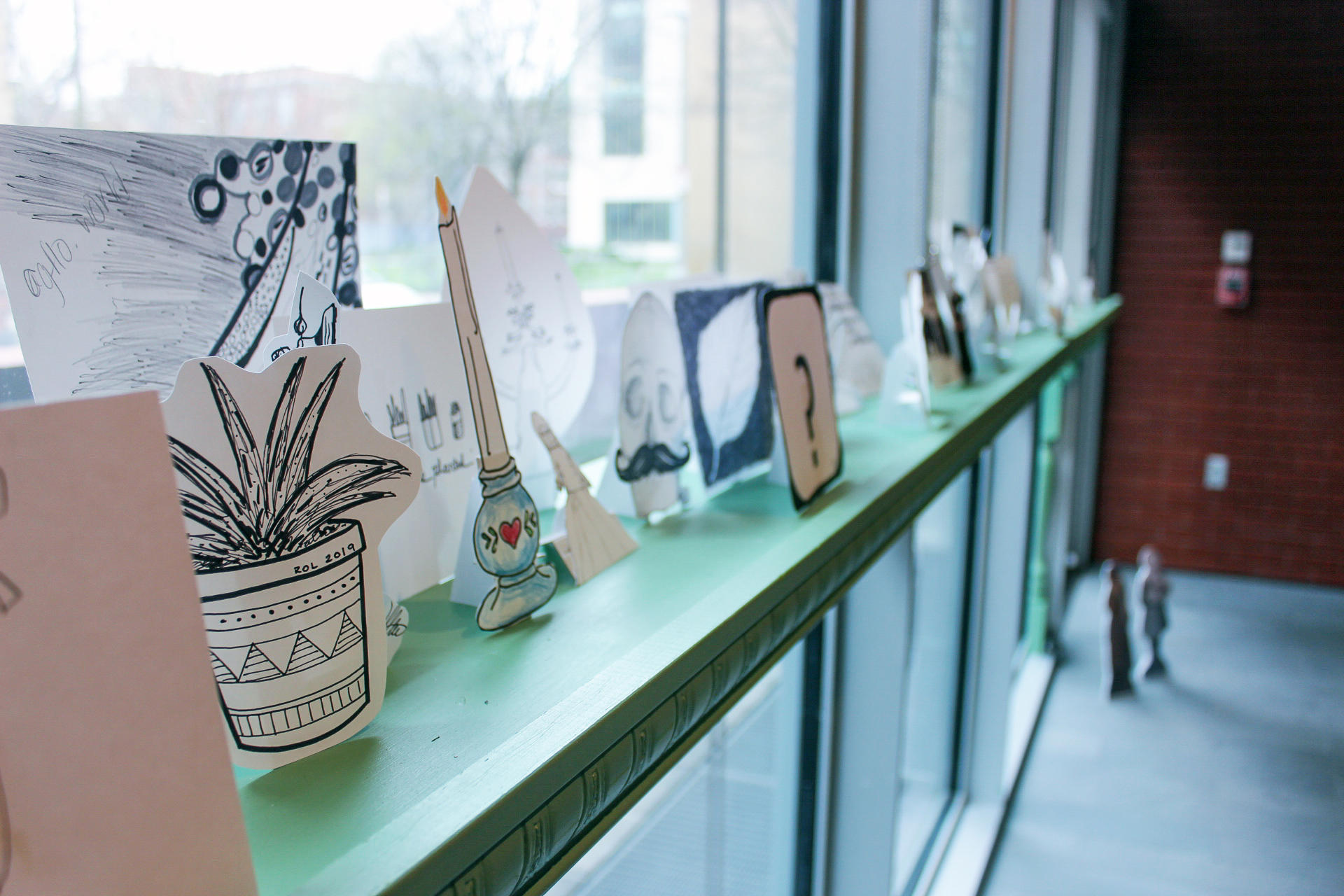 Piecing Together mantel installation in the Bertucci Education Studio, created in collaboration with Visiting Studio Artist Venetia Dale. Drawn objects contributed to the installation by Museum visitors.